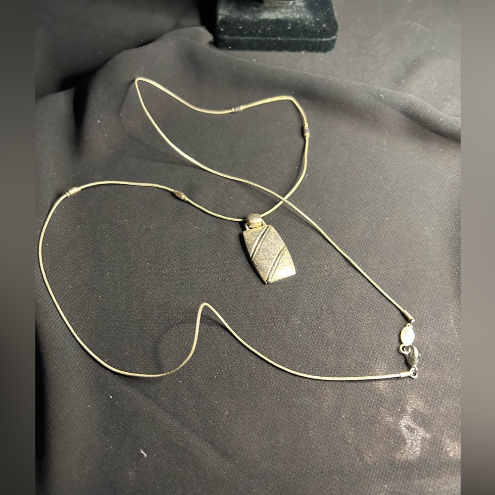 CH Tagged Silver tone Metal long length necklace. The tag reads CH.